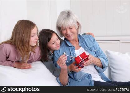 Girls offering present to grandmother