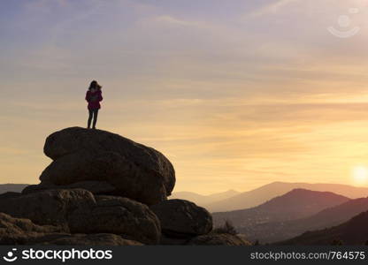 Girls playing at sunset on top of the mountain