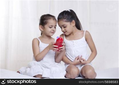 Girls playing with a toy at home