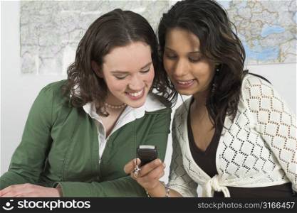 Girls reading a text message on a cellphone