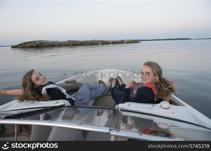 Girls relaxing on a boat, Lake of The Woods, Kenora, Lake of The Woods, Ontario, Canada