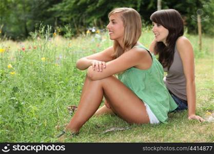 Girls sitting in a field