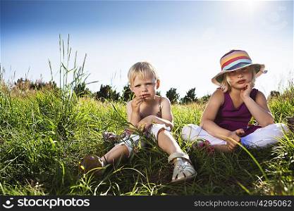 Girls sitting together in grass