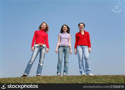girls stand on meadow