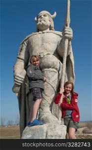 Girls standing on the Viking statue in Gimli, Manitoba Canada