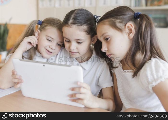 girls using tablet school