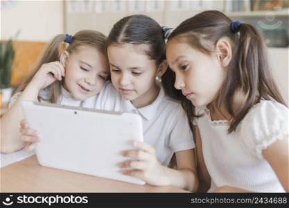 girls using tablet school