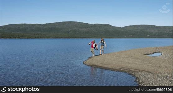 Girls walking on the beach, Trout River Pond, Gros Morne National Park, Newfoundland and Labrador, Canada