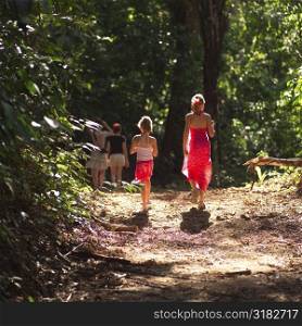 Girls walking through forest