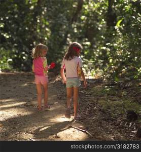 Girls walking through forest in Costa Rica