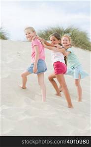 Girls walking up a sand dune
