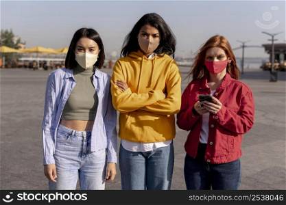 girls wearing medical masks outside