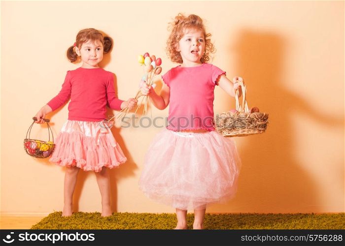 Girls with baskets on the Easter Egg hunt. Girls on an Easter Egg hunt