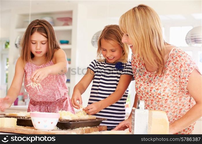 Girls With Mother Making Cheese On Toast