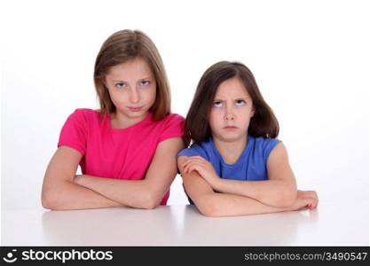 Girls with serious expression on white background