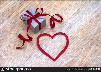 give a gift, gray gift box with red ribbon, valentine"s day february 14, birthday gift, valentine"s day decor. gray gift box with red ribbon, valentine"s day february 14, birthday gift, give a gift, valentine"s day decor