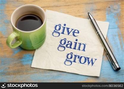 give, gain and grow -personal development concept - handwriting on a napkin with a cup of coffee