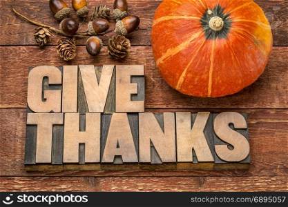 give thanks - Thanksgiving concept - word abstract in letterpress wood type printing blocks with winter squash and acorn decoration