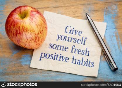 Give yourself some fresh positive habits - motivational handwriting on a napkin with an apple