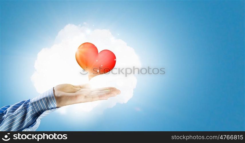 Giving love. Close up of hands holding red heart