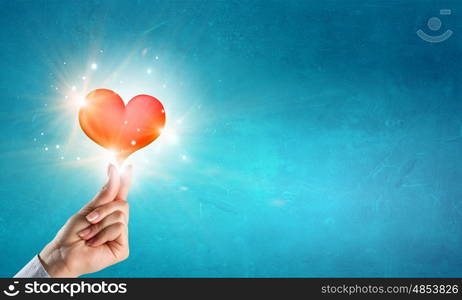 Giving love. Close up of hands holding red heart