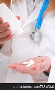 Giving pills. White pills in doctor&rsquo;s hand.