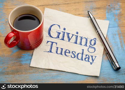 Giving Tuesday - handwriting on a napkin with a cup of espresso coffee