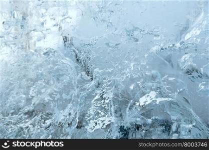 Glacial transparent block of ice (close up) with interesting drawings and patterns. Background.