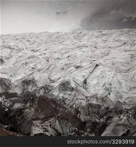 Glacier ice field in misty mountain valley