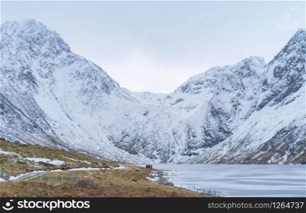Glacier. Ice lake in Lofoten islands, Nordland county, Norway, Europe. White snowy mountain hills and trees, nature landscape background in winter season. Famous tourist attraction
