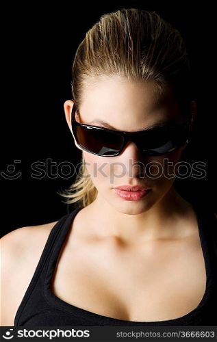 glamor portrait of a blond mistery woman with sunglasses looking down