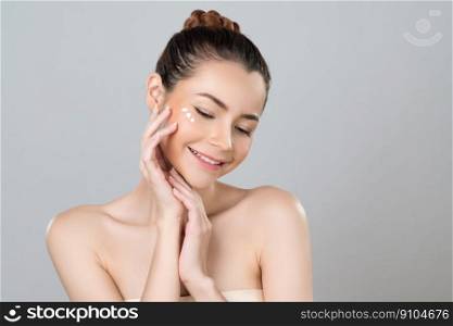 Glamorous beautiful perfect clean skin soft makeup woman finger applying moisturizer cream on her face under contour eye for anti aging wrinkle. Facial skin rejuvenation in isolated background.. Glamorous woman applying moisturizer cream on her face for perfect skin