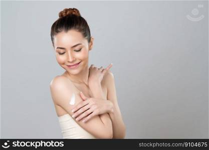Glamorous beautiful woman applying moisturizer cream on her arm for perfect skincare treatment in isolated background. Soft makeup young girl portrait with skin rejuvenation and cosmetology concept.. Glamorous beautiful woman applying moisturizer cream on her arm for perfect skin