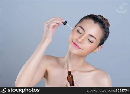 Glamorous portrait of beautiful woman applying extracted cannabis oil bottle for skincare product. CBD oil dropper pipette for cosmetology treatment and cannabinoids concept in isolated background.. Glamorous portrait of woman applying CBD oil skincare treatment.