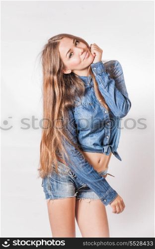 Glamorous young sexy woman with long hair weared jeans wear. Vertical shot