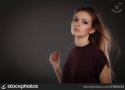 Glamour and beauty. Portrait of gorgeous glamorous fashionable woman with long straight dark hair waving. Stunning young elegant lady.. Glamorous stunning woman with waving hair.