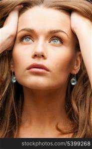 glamour, beauty and health, concept - beautiful calm woman with beautiful earrings holding head and looking up