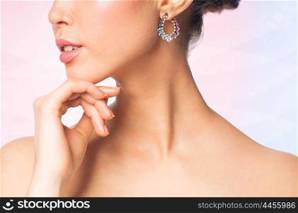 glamour, beauty, jewelry and luxury concept - close up of beautiful woman face with earring over rose quartz and serenity gradient background