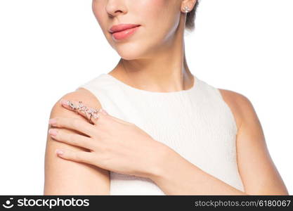 glamour, beauty, jewelry and luxury concept - close up of beautiful woman with golden ring and diamond earring