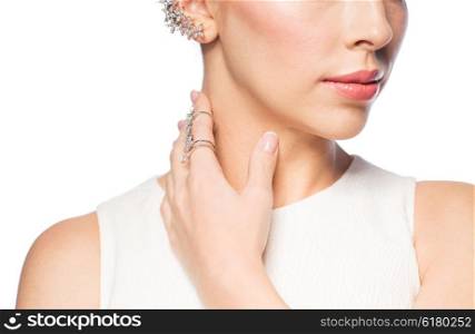 glamour, beauty, jewelry and luxury concept - close up of beautiful woman with golden ring and diamond earring