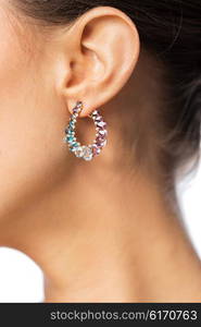 glamour, beauty, jewelry and luxury concept - close up of beautiful woman face with earring