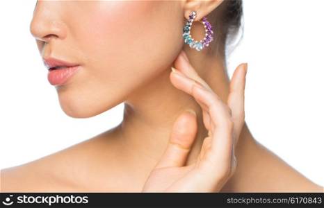 glamour, beauty, jewelry and luxury concept - close up of beautiful woman face with earring