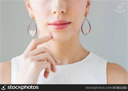 glamour, beauty, jewelry and luxury concept - close up of beautiful woman face with pearl earrings
