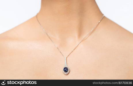 glamour, beauty, jewelry and luxury concept - close up of beautiful woman neck with pendant