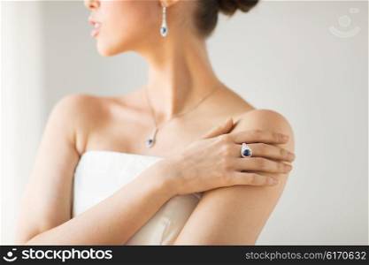 glamour, beauty, jewelry and luxury concept - close up of beautiful woman with finger ring
