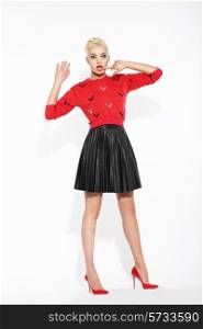 Glamour. Blonde Posing in Red Blouse and Black Skirt