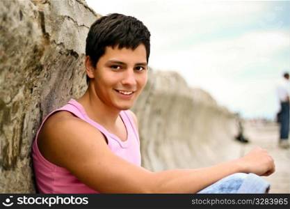 Glamour handsome teenager in pink t-shirt outdoors. Glamour handsome teenager outdoors