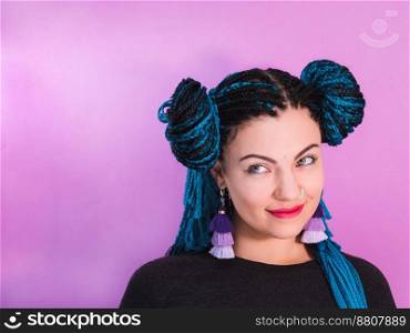 Glamour portrait of sexy woman with african blue braids hairstyle, bindi, nose ring and tassel earrings isolated on colorful background.. Glamour portrait of sexy woman with african blue braids hairstyle, bindi, nose ring and tassel earrings isolated on colorful background. Freaky girl. Copy space.