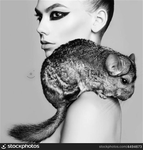 Glamour portrait of young beautiful woman with chinchilla