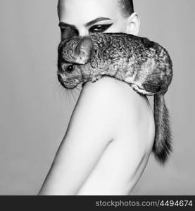 Glamour portrait of young beautiful woman with chinchilla